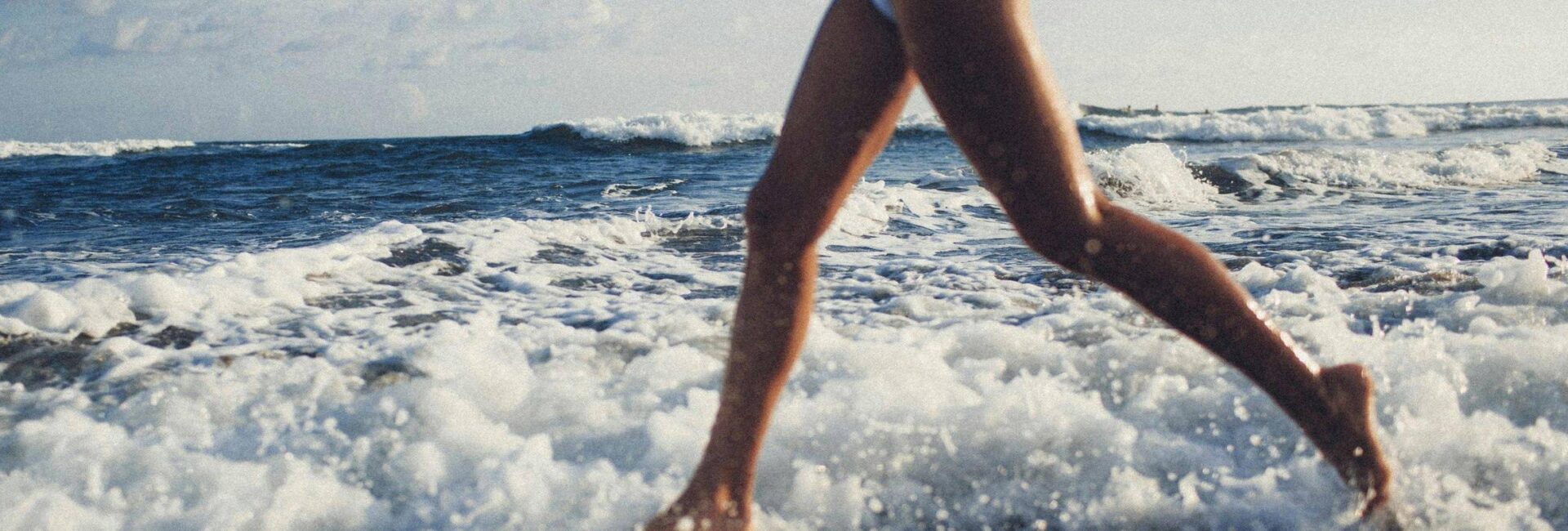 woman running in ocean