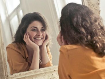 woman smiling looking in mirror